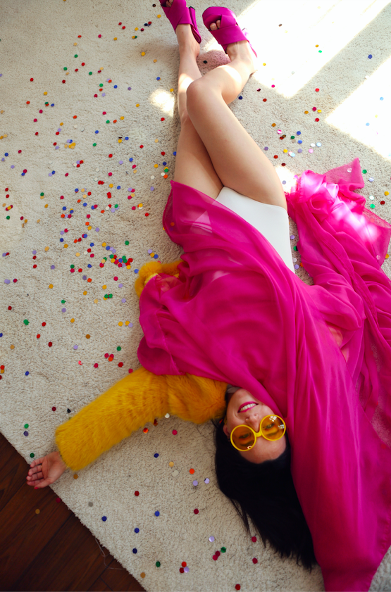 Mary lying on a carpet with confetti